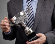 Image of man holding an award