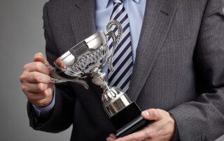 Image of man holding an award